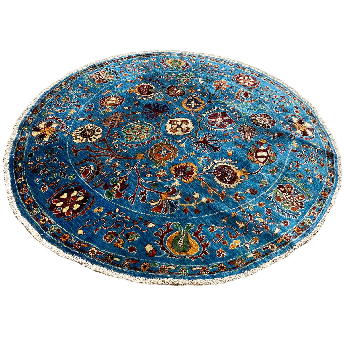Rundteppich aus Wolle in Blau mit symmetrischem Ornamentfeld und Zierbordüre