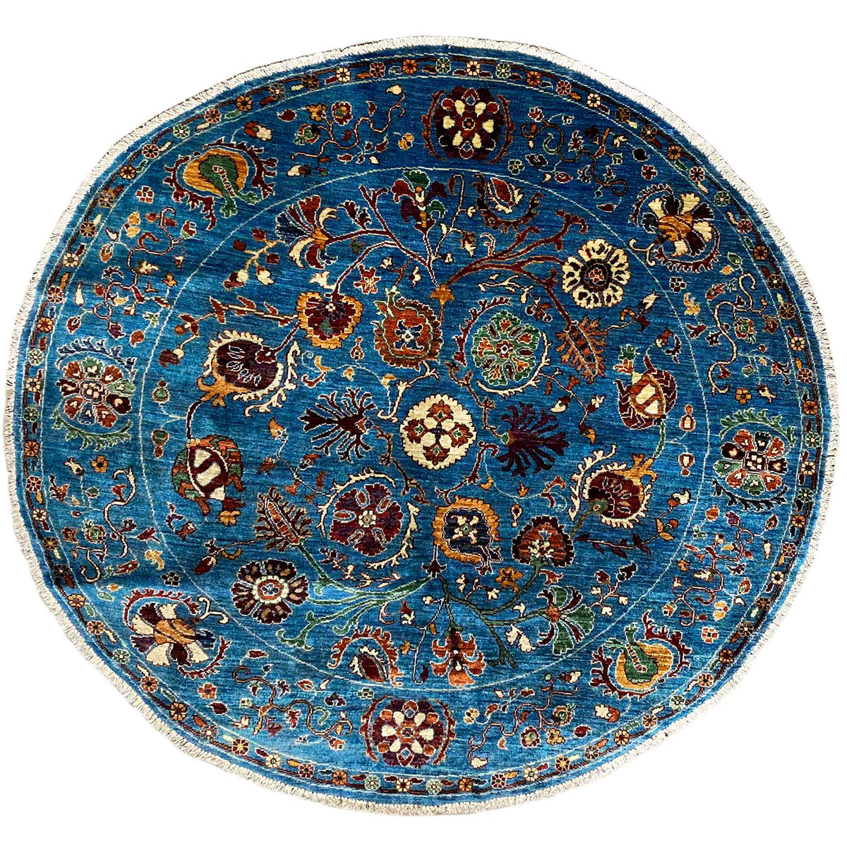 Rundteppich aus Wolle, blau, mit farbigem Ornamentmuster und hell abgesetztem Rand