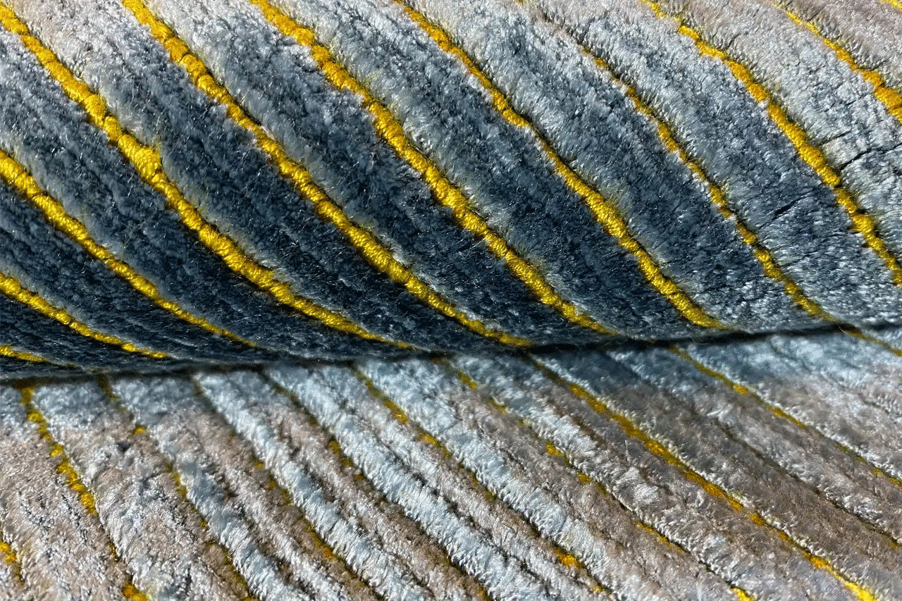 Detailansicht: Blau-grauer Teppich mit gelben, schmalen Linien und kurzem Flor