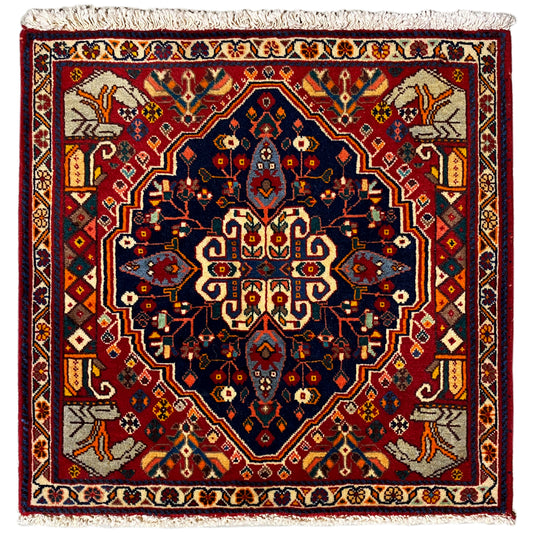 Teppich mit rotem Rand und blauem Medaillonmuster, gewebter Bordüre und Fransen