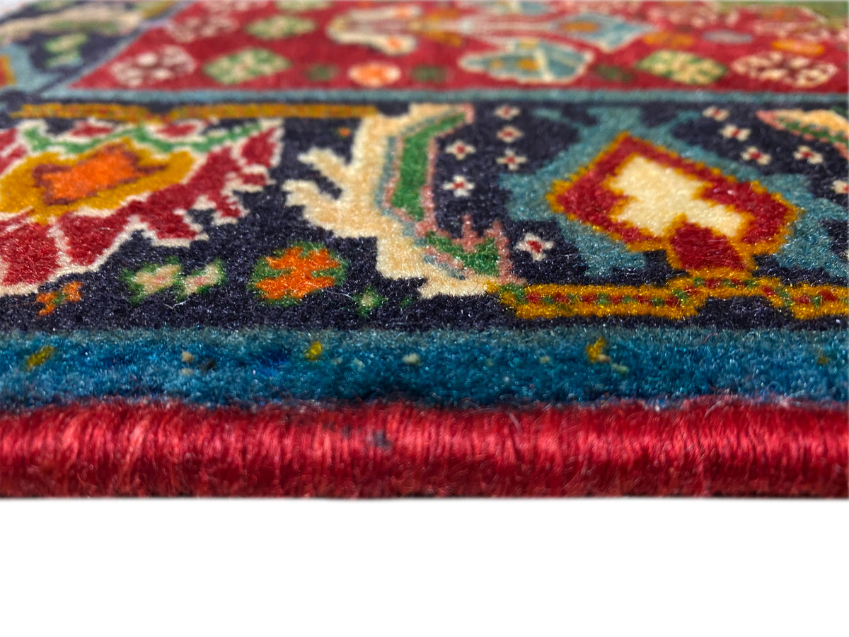Teppichrand im Detail: mehrfarbiges Ornamentmuster und dichter Flor mit Fransenabschluss