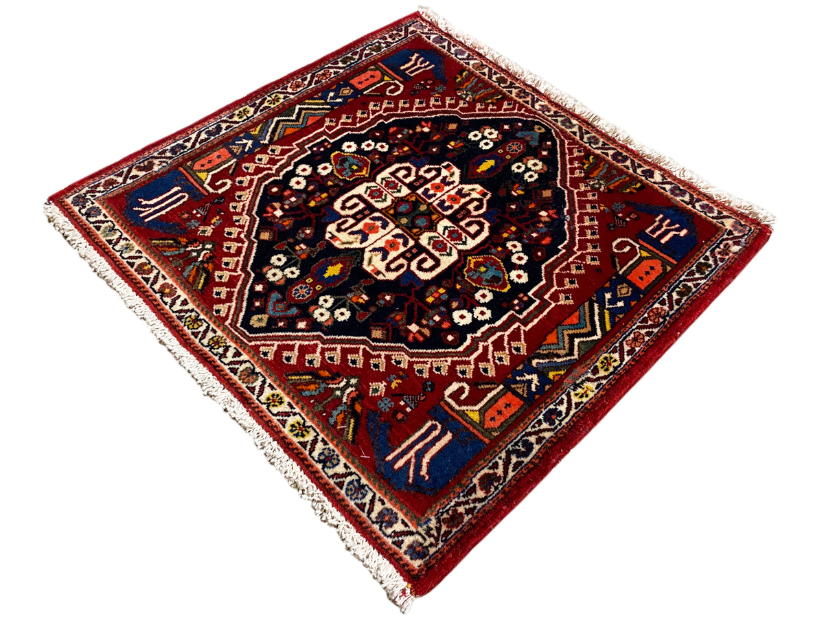Teppich mit rotem Rahmen und dunkelblauem Zentrum, sternförmiges Ornament, Fransen