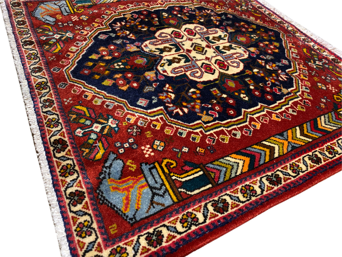 Poshti Teppich 65x61 cm Detailansicht: rotes Feld, blau-schwarzes Ornament, Kontrastkanten