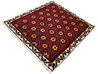 Quadratischer Teppich diagonal mit rotem Grund und mehrfarbigen Stern-Quadraten